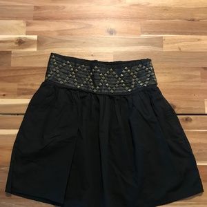 black skirt with studs at the waist